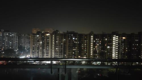 a view of a city at night with lights at The dream studio in Noida