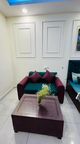 a living room with a couch and a table at The dream studio in Noida