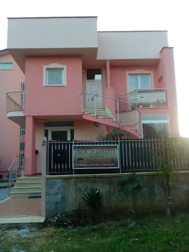 a pink house with stairs and a balcony at 60Quattro bedrooms in Lamezia Terme