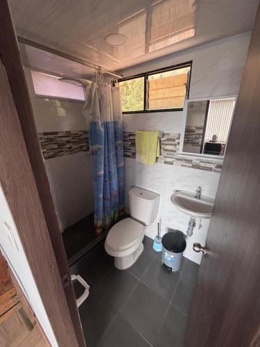 a small bathroom with a toilet and a sink at Cabaña Belvedere in Duitama