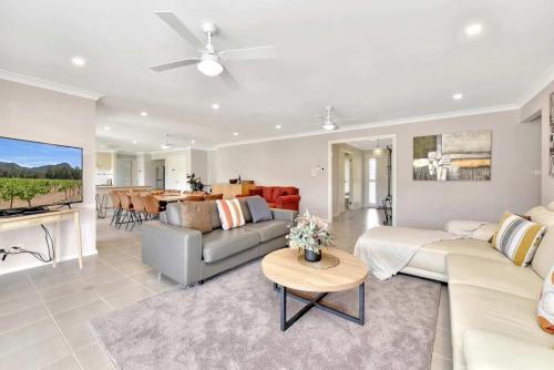 a living room with a couch and a table at Marignano Homestead in Broke