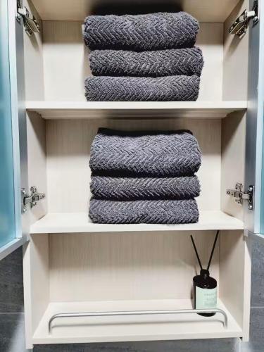 a shelf with three towels in a bathroom at 스테이일룸 in Sŭngch'ŏn-ni