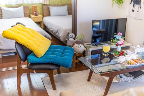 a living room with a chair and a table at Unbi Stay in Nakijin