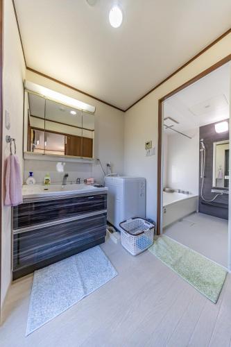 a bathroom with a sink and a refrigerator at Unbi Stay in Nakijin