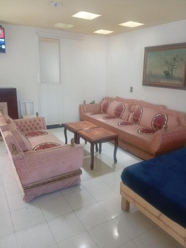 a room with couches and a table in a room at Hospedaje Villa Posadas in Momoxpan