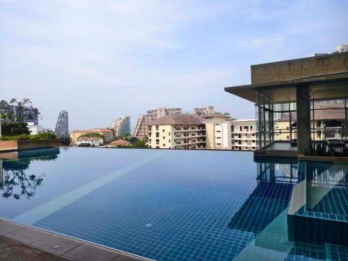 a swimming pool on the roof of a building at Studio 5mins to Terminal 21 Lumpini Ville Naklua in North Pattaya