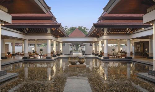 a lobby with a fountain in the middle of a building at Banyan Tree Phuket in Bang Tao Beach