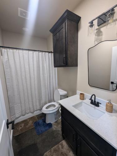 a bathroom with a toilet and a sink and a mirror at Special Deal on 2 Bedroom Unit 556 in Paris