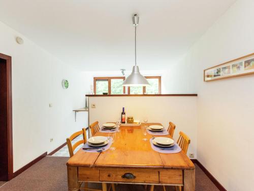 a dining room with a wooden table and chairs at Boutique Pet friendly Apartment in Bohon in Barvaux