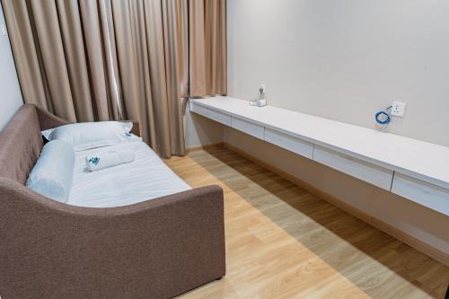 a living room with a couch and a sink at KT Seaview City Suite in Kuala Terengganu