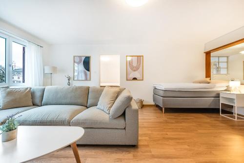 a living room with a couch and a bed at SOHO A !Gratis parken, Free Parking! in Kreuzlingen