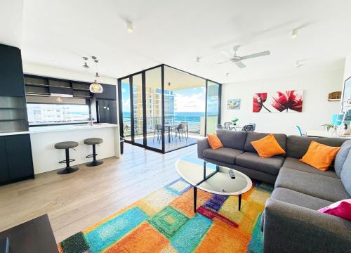 a living room with a couch and a table at 5th Floor Beachside Ocean View with Wi-Fi, Pool and Gym in Gold Coast