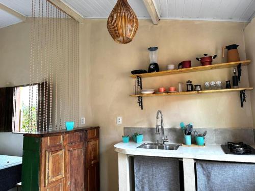 a kitchen with a sink and a counter top at Casa Esmeralda in Lençóis