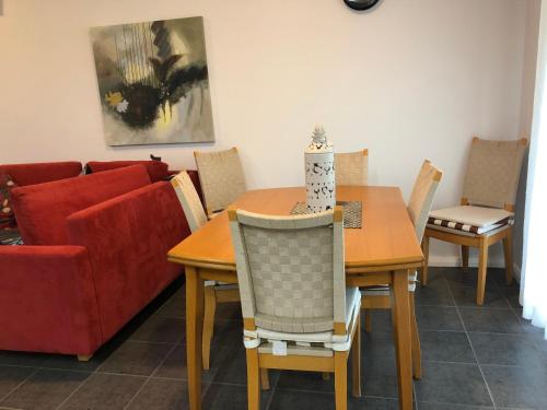 a dining room with a table and a red couch at York - Mulyinjinin Valley Cottage in York