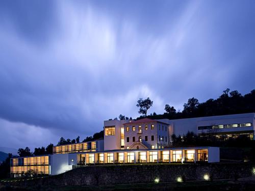 a large building with its lights on at night at Douro Palace Hotel Resort & SPA in Baião