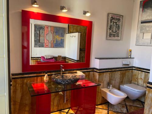 a bathroom with a sink and a toilet and a mirror at Beautiful Apartment Teatro Cervantes in Málaga