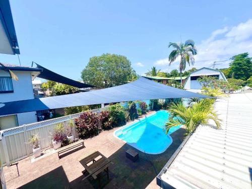 an overhead view of a swimming pool with a tent over it at Kirrama 4 Family Beachside Escape in Mission Beach