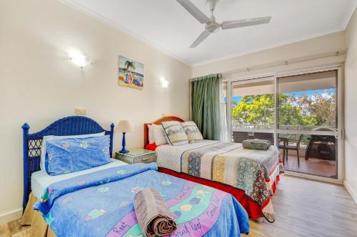 a bedroom with two beds and a window at Ulysses 10 Ocean Dunk Island Views in Mission Beach