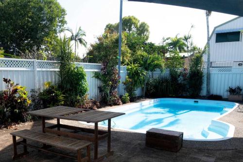 a small pool with a table and a picnic table at Kirrama 2 Pool across road to beach in Mission Beach