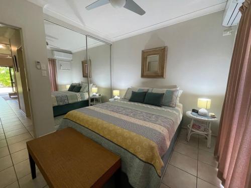 a hotel room with a bed and a mirror at Liana 4 Beach Lovers All at your finger tips in Mission Beach