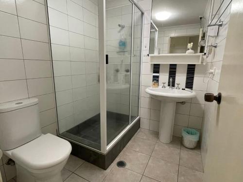 a bathroom with a shower and a toilet and a sink at Liana 4 Beach Lovers All at your finger tips in Mission Beach