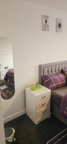 a bedroom with a bed and a mirror at Excellent 2 bedroom Apartment- great Connectivity to central london in Barking