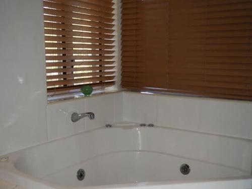 a bath tub in a bathroom with a window at BHA 1 Beachfront Haven fullhouse in Mission Beach