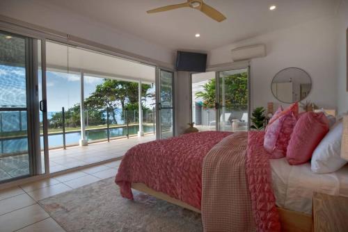 a bedroom with a bed and a large window at Tide Pool Ocean Front Full house in South Mission Beach