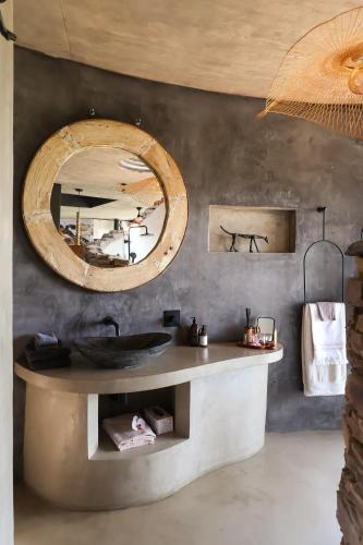 a bathroom with a sink and a mirror at Cypiro Leopard Lodge in Kransberg