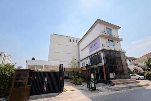 a white building with a fence in front of it at The Grand Imperial in Ban Song Hong