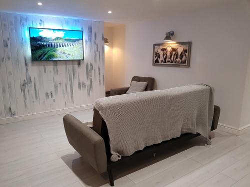 a bedroom with a bed and a chair in a room at Cottage Apartment - Uk2774 in Llandudno