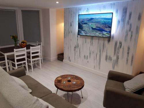 a living room with a couch and a table at Cottage Apartment - Uk2774 in Llandudno