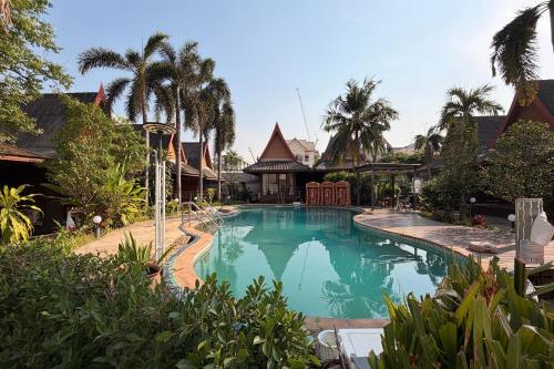 a swimming pool in the middle of a house at The Grand Imperial in Ban Song Hong