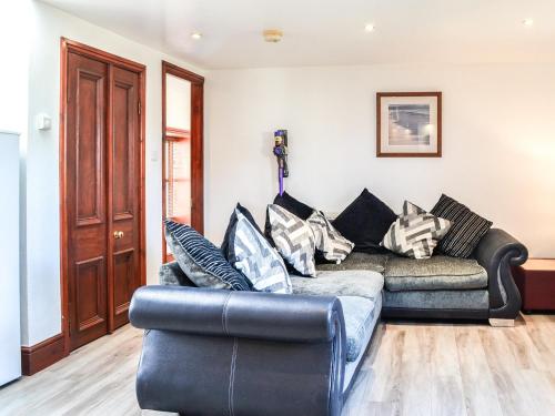 a living room with a couch and a chair at Ochiltree Cottage - Uk7781 in Newton Stewart