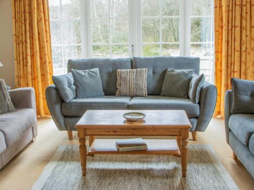 a living room with a couch and a coffee table at Greenlands in Banchory