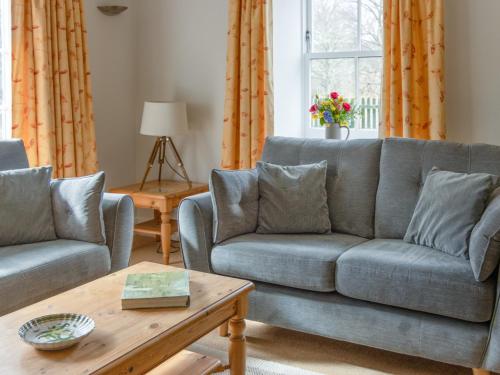 a living room with two couches and a coffee table at Greenlands in Banchory