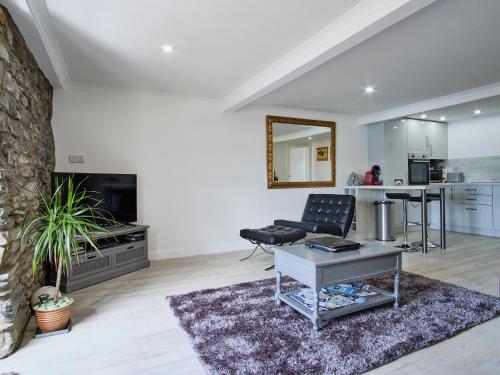 a living room with a couch and a table at Imperial Apartment in Oban