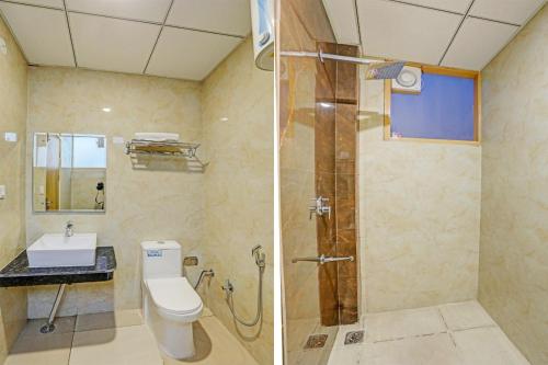 a bathroom with a shower and a toilet and a sink at Hotel IBY in New Delhi