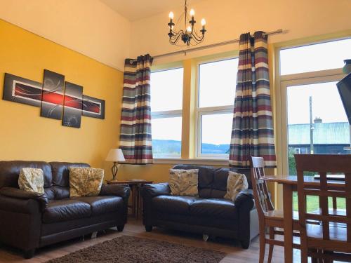 a living room with two chairs and a table at Uk7522 - Science in Dallavich