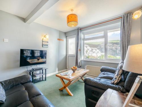 a living room with a couch and a table at 6 Mount Brioni in Downderry