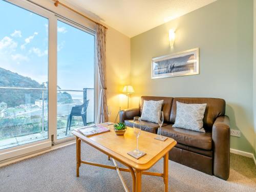 a living room with a couch and a table at 12 Mount Brioni in Downderry