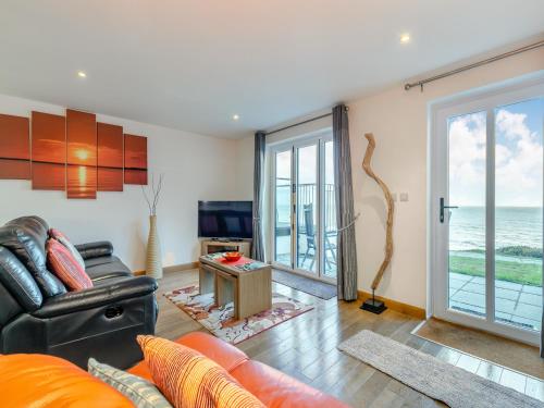 a living room with a couch and a television at 21 Mount Brioni in Downderry
