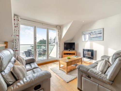 a living room with two couches and a television at 18 Mount Brioni in Downderry