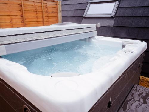 a hot tub with water in it in a backyard at Willow-Uk7589 in Stewarton