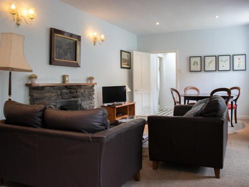 a living room with two couches and a fireplace at Marble Lodge - Uk7635 in Pitlochry