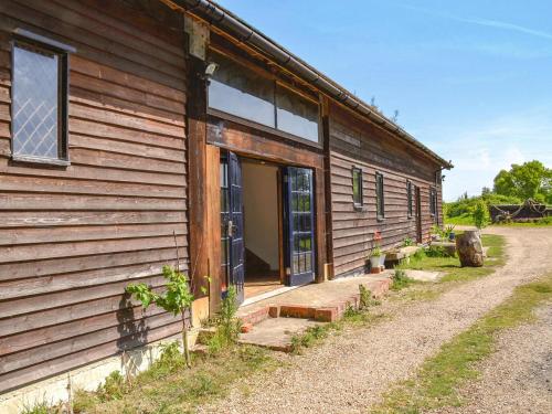 a building with a door on the side of it at The Timber Store in Hardham
