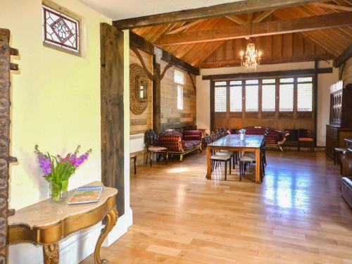 a living room with a table and a dining room at The Timber Store in Hardham