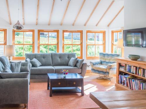 a living room with a couch and a table at East Balnacraig in Banchory