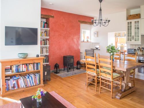 a living room with a wooden table and a dining room at East Balnacraig in Banchory