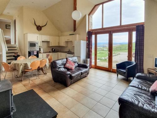 a living room with a couch and a table at The Byre - Uk7790 in Milton of Auchinhove